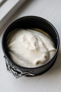 Cheesecake filling that has just been poured into a springform pan.