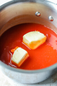 Hot Sauce and butter in a pot.