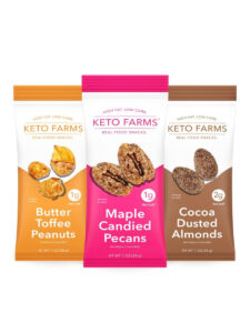 Three bags of keto farms real food snacks. The left is butter toffee peanuts, in the middle is maple candy pecans, and on the right is cocoa dusted almonds.