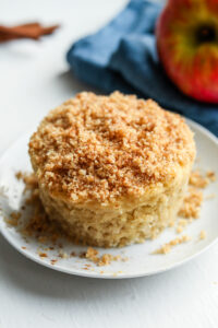 An apple spice cake on a white plate.