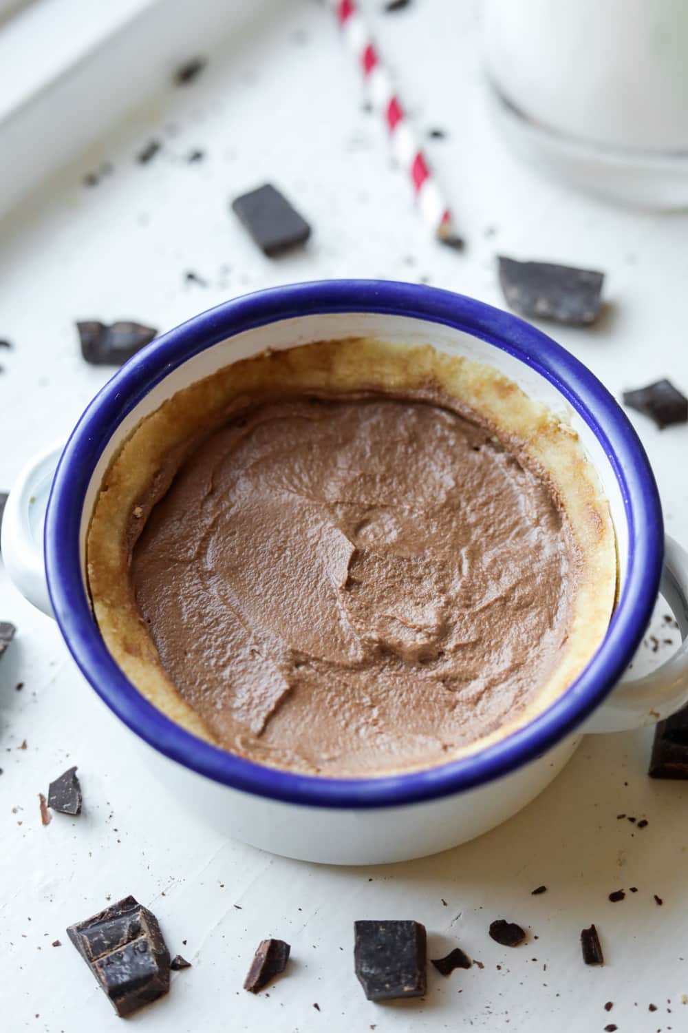 A white ball with a blue rim filled with chocolate pie.