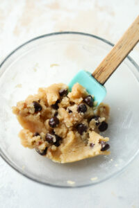 A glass bowl filled with cookie dough.