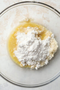 Butter, almond flour, and sweetener in a glass bowl.