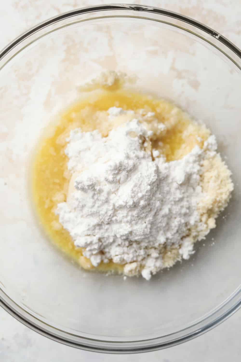 Butter, almond flour, and sweetener in a glass bowl.