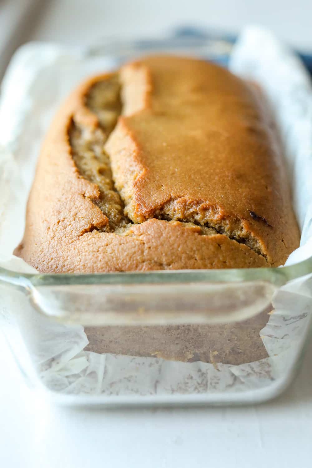 A loaf of bread inside of a glass baking dish.