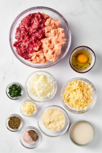 Ingredients for keto meatballs on a white counter.