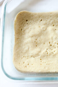 Bread in a clear glass dish.