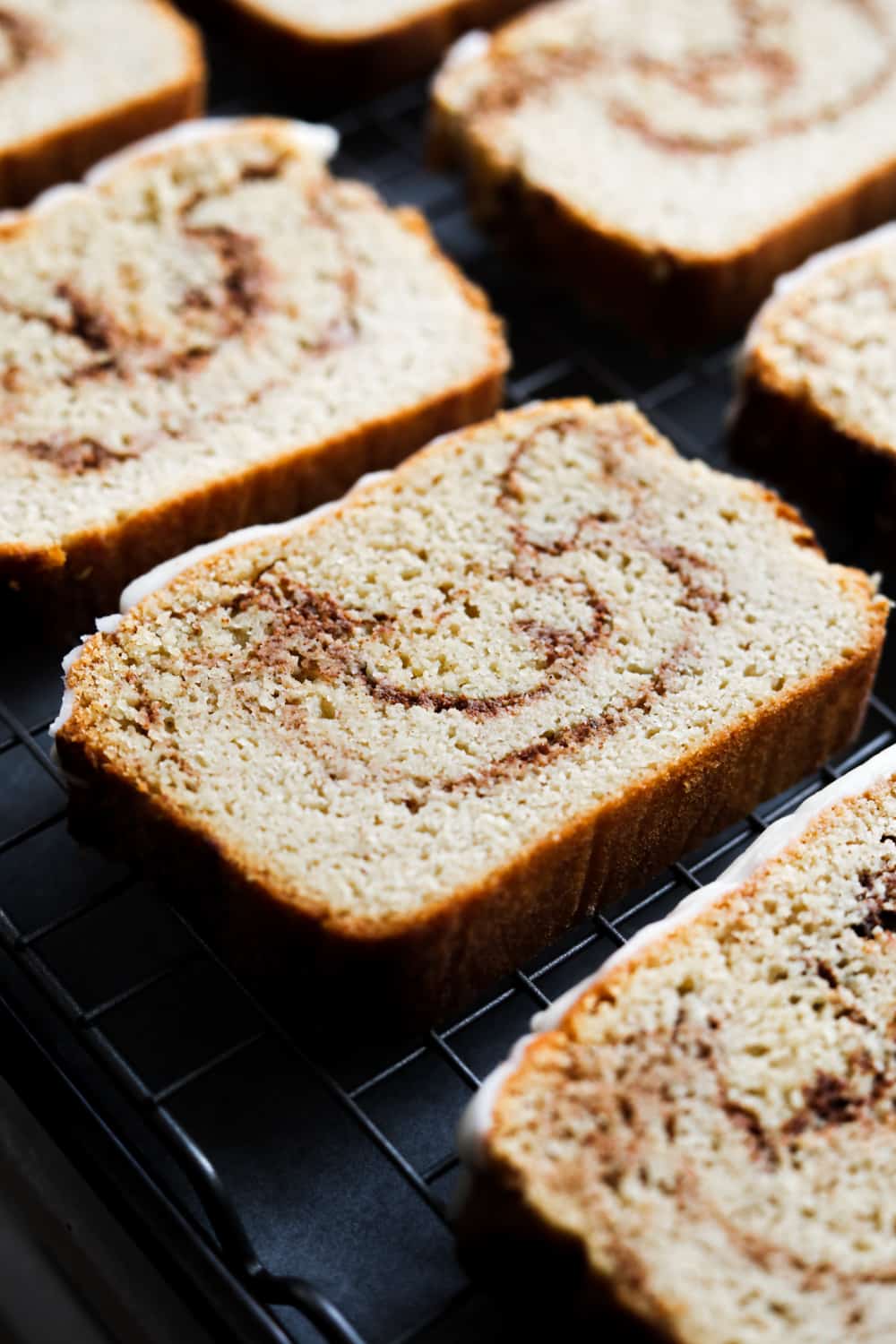 Slices of cinnamon swirl bread on a drying rack.