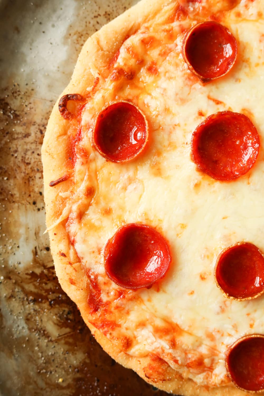 Half of a cheese and pepperoni pizza set on a tray.