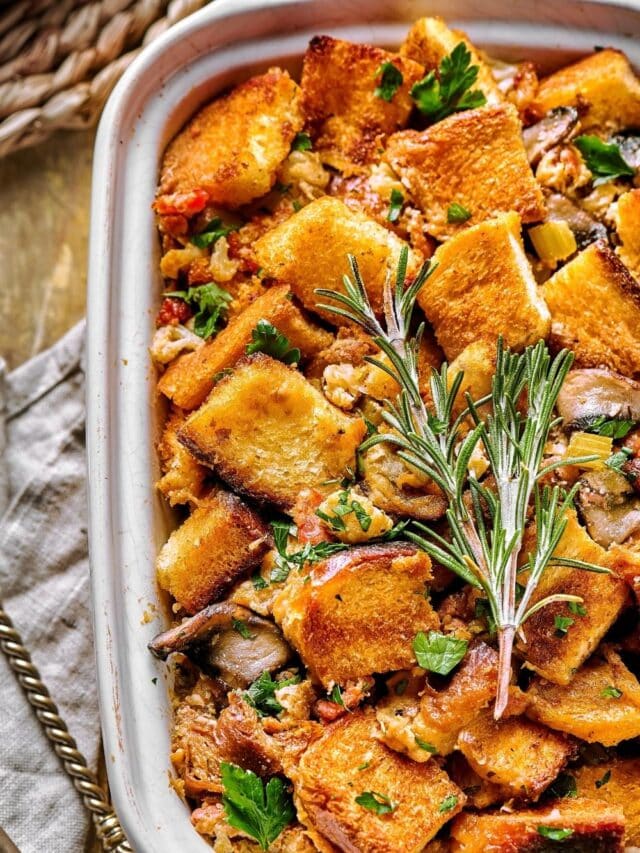 Part of a white casserole dish filled with stuffing.
