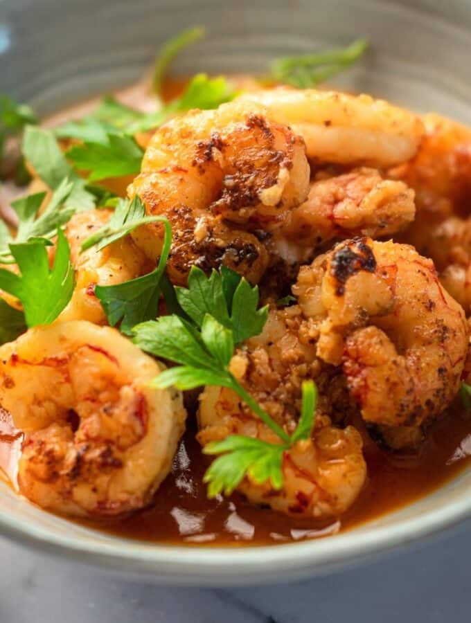 A bunch of shrimp in part of a gray bowl.