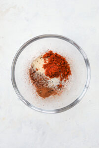 A mixture of spices and seasonings in a glass dish.