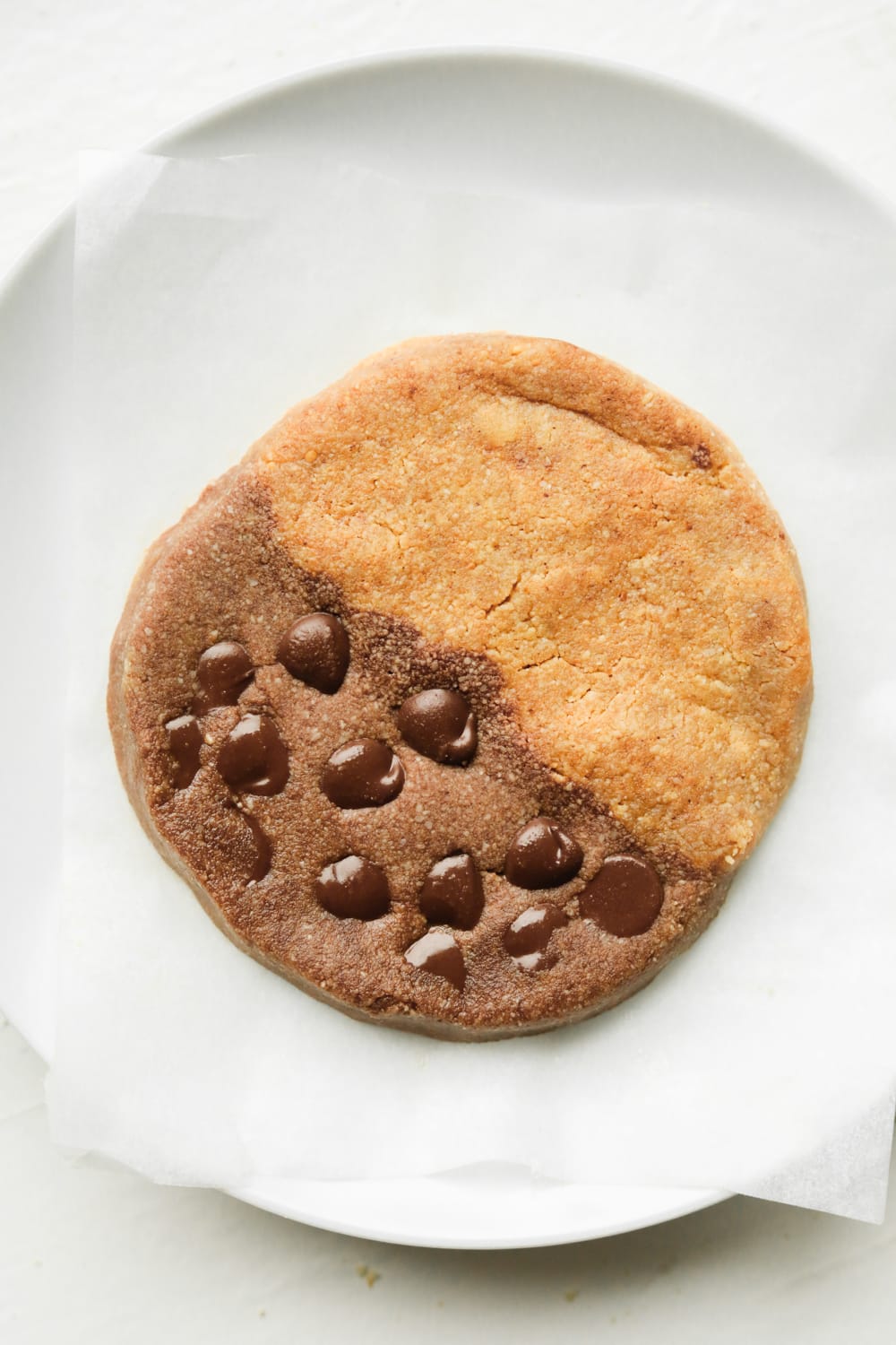 A chocolate and peanut butter cookie on a white plate.