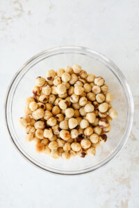 A bowl full of deskinned hazelnuts.