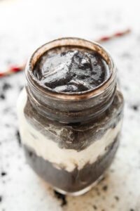 An Oreo protein shake in a glass jar.