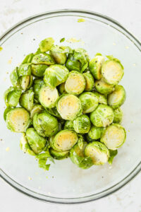 A bowl full of seasoned halved brussels sprouts.