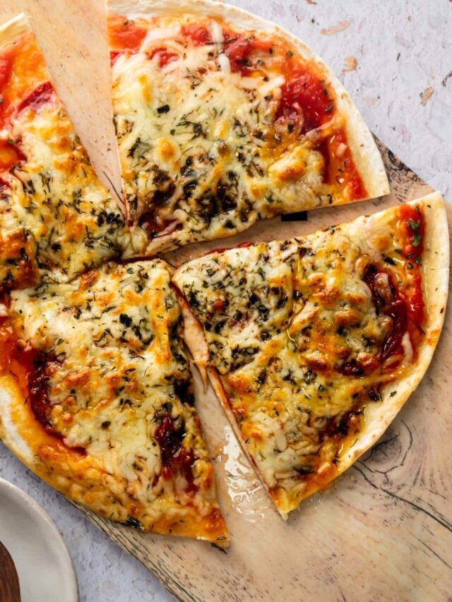Three slices of tortilla pizza on top of a wooden cutting board.