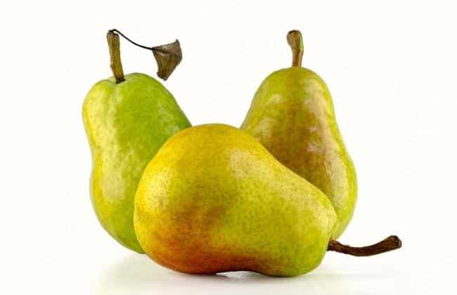 A pear on its side and two pears standing straight up.