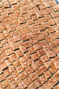 Uncooked cereal on a black cutting board.