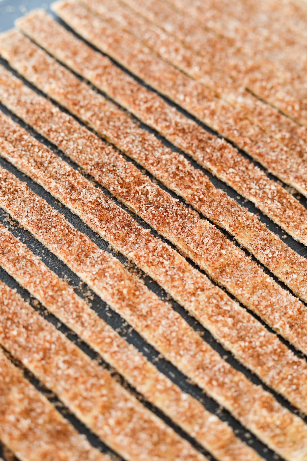 Quarter inch wide strips of lavash bread that has been cut into rows. There is a cinnamon "sugar" topping that has been added to the bread.