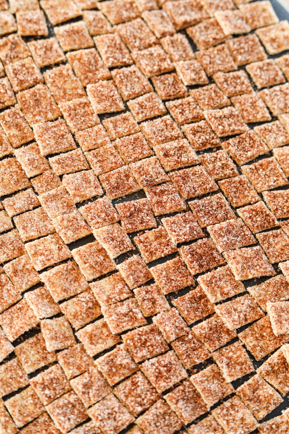 Uncooked cereal on a black cutting board.