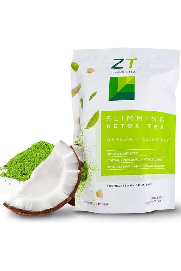 A bag of ZT slimming detox tea with a half of a coconut and some match powder next to it.