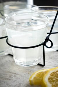 A glass of chick fil a diet lemonade in a wire holder.