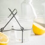 A glass of chick fil a lemonade in a wire holder.