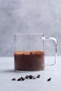Protein mug cake batter in a glass mug.