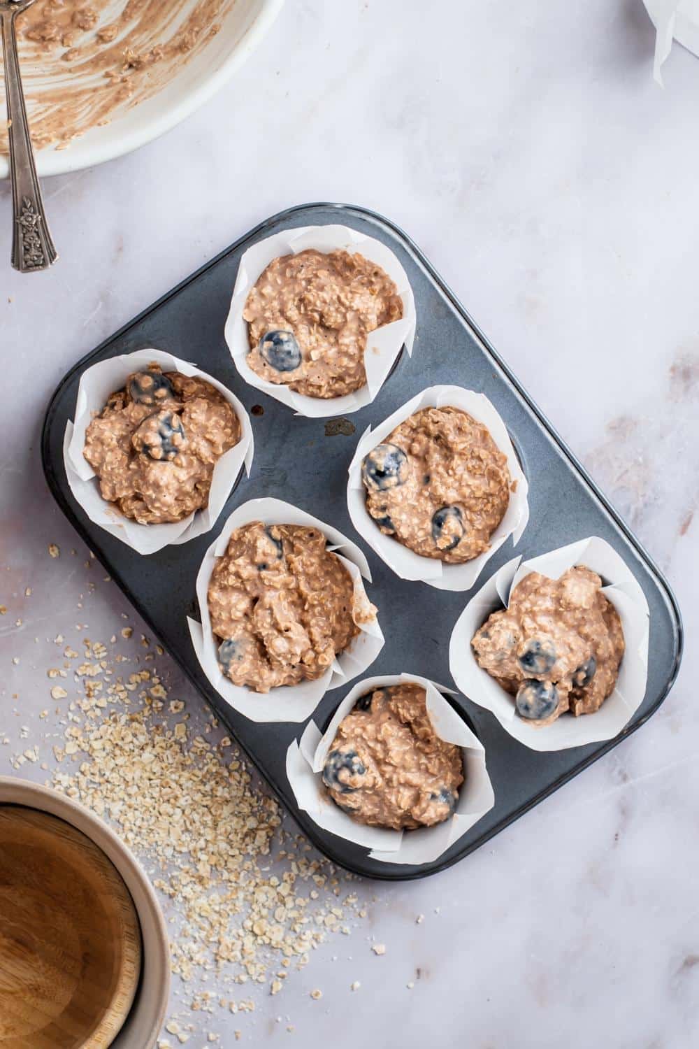 Protein blueberry muffins in a muffin tin.