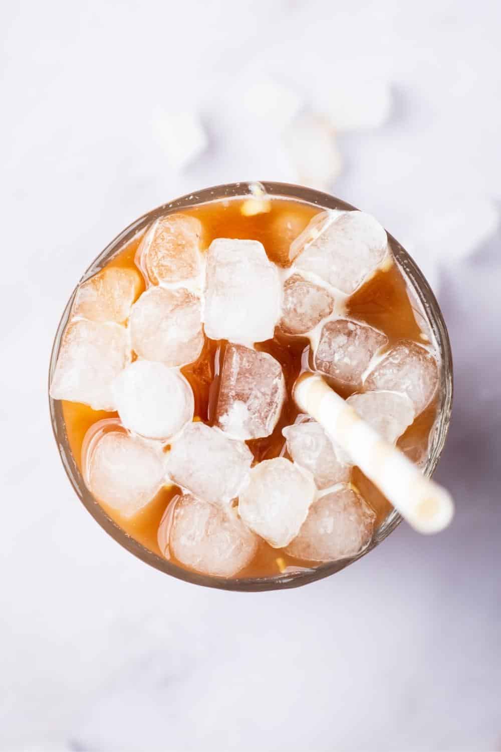 Ice cubes on in a glass that is filled with protein coffee.