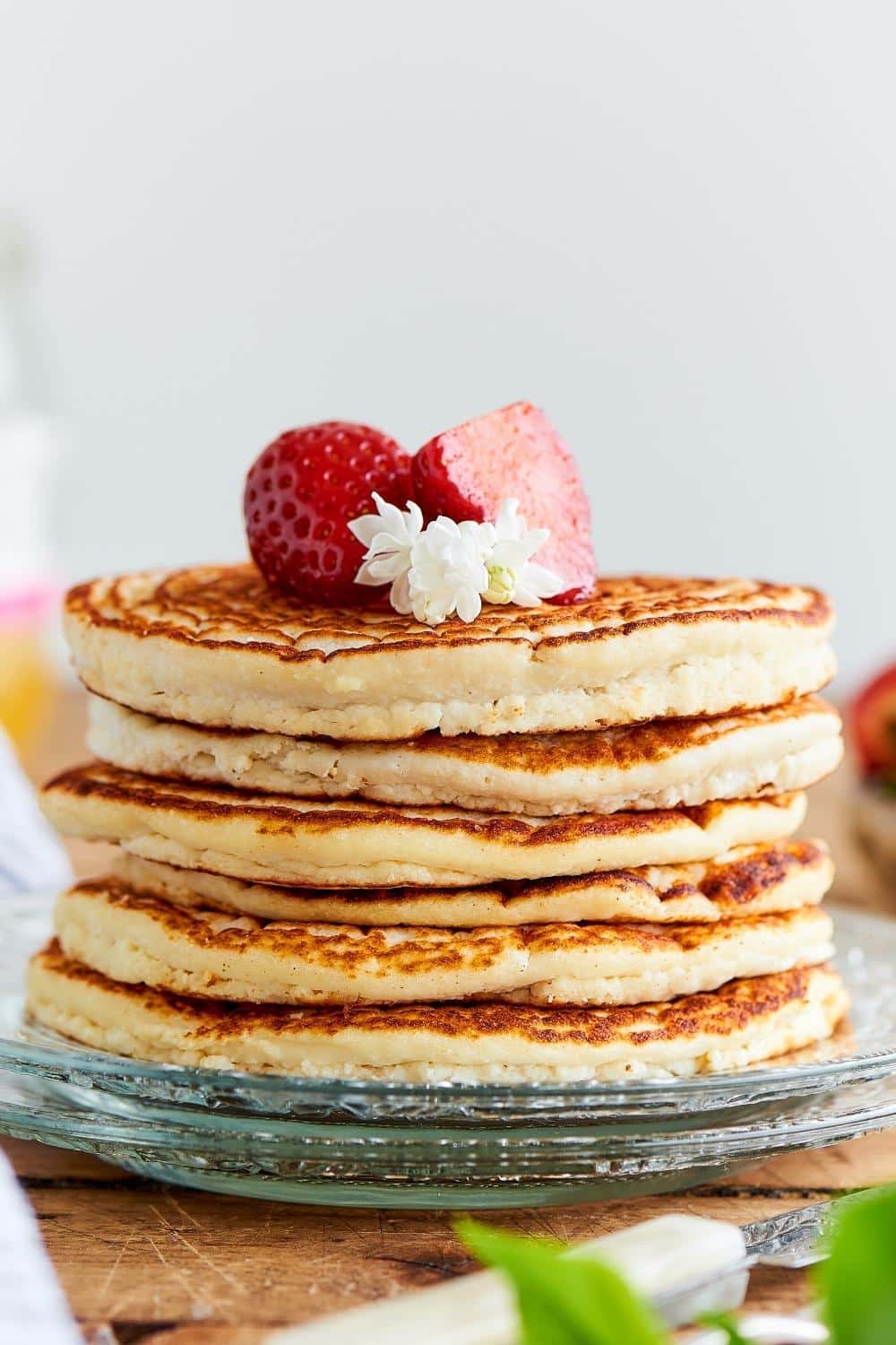 A stack of six protein pancakes on a glass plate.