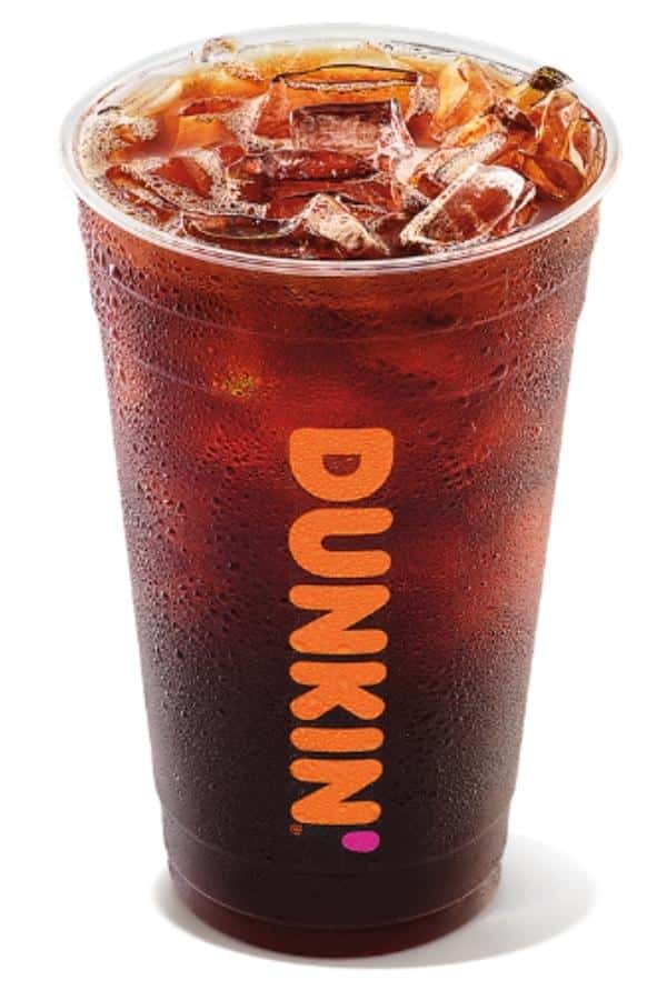 A clear cup of dunkin donuts iced americano.