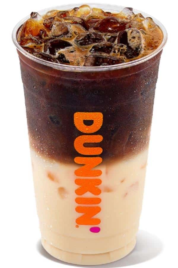 A clear cup filled with dunkin donuts iced macchiatto.