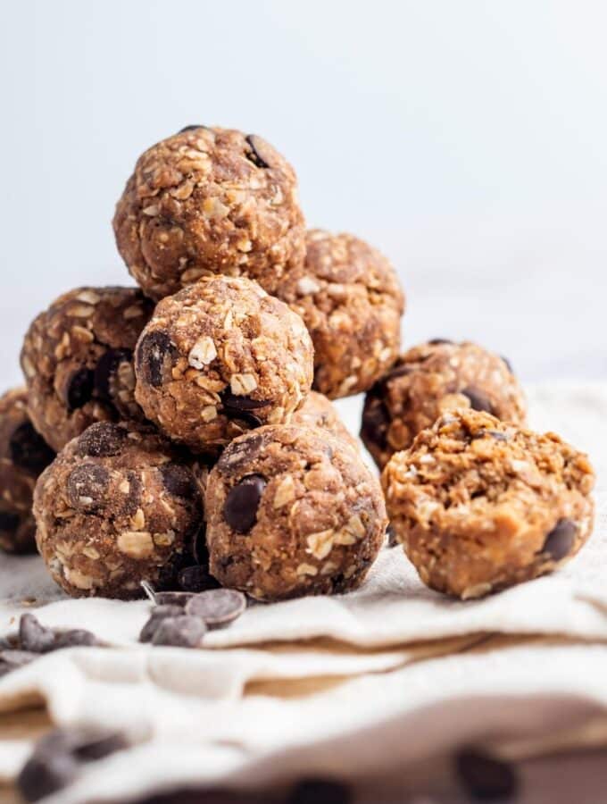 A bunch of protein balls on top of each other a tablecloth.