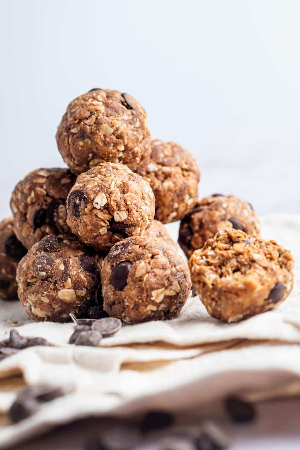 A bunch of protein balls on top of each other a tablecloth.