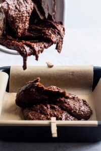 A square of cut brownies on a piece of parchment paper.