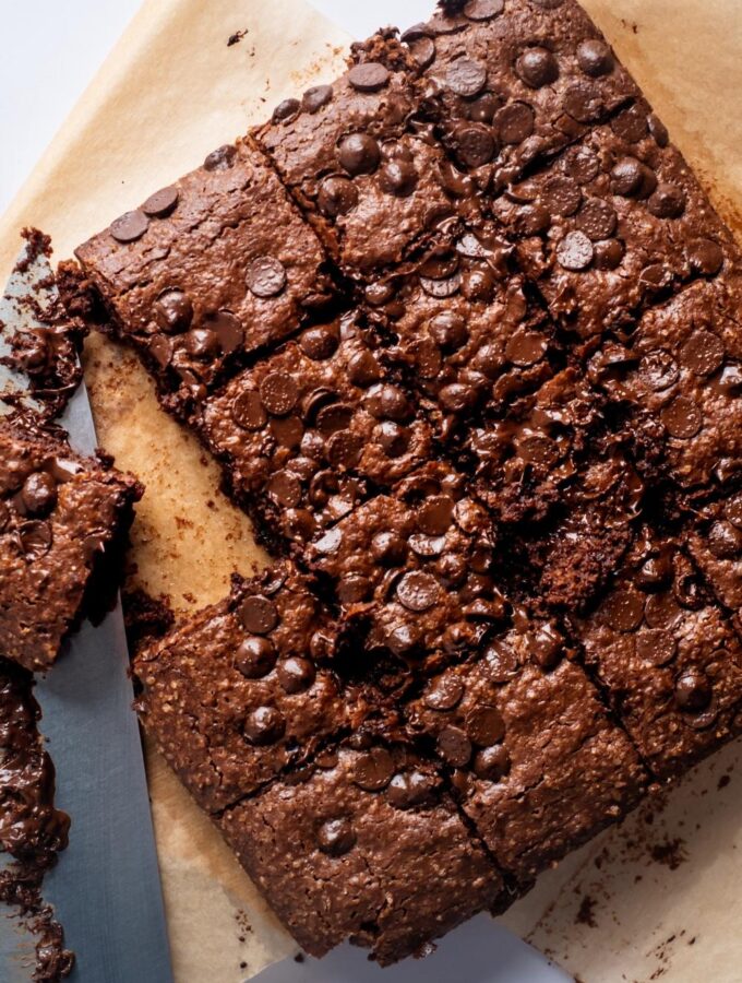 A square of cut brownies on a piece of parchment paper.