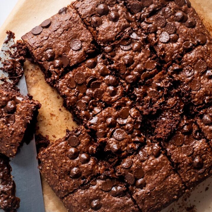 A square of cut brownies on a piece of parchment paper.