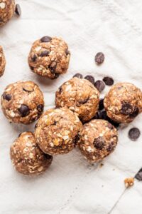Peanut butter protein balls on a white table cloth.