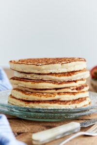 A stack of six protein pancakes on a plate.