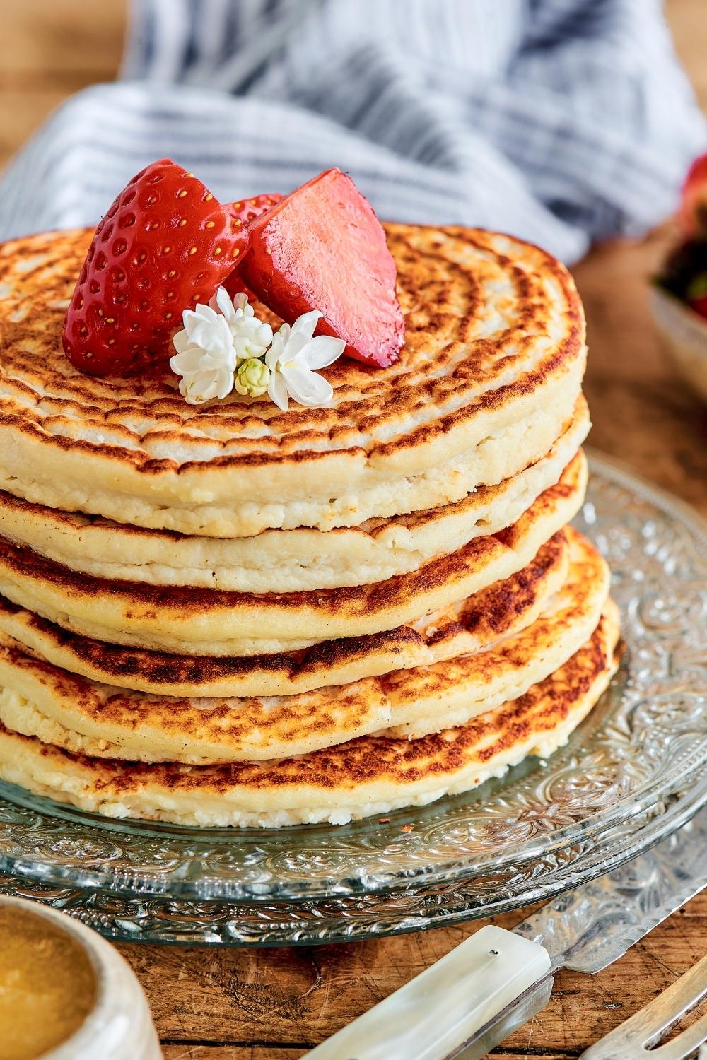 Part of a stack of six protein pancakes on a serving plate.