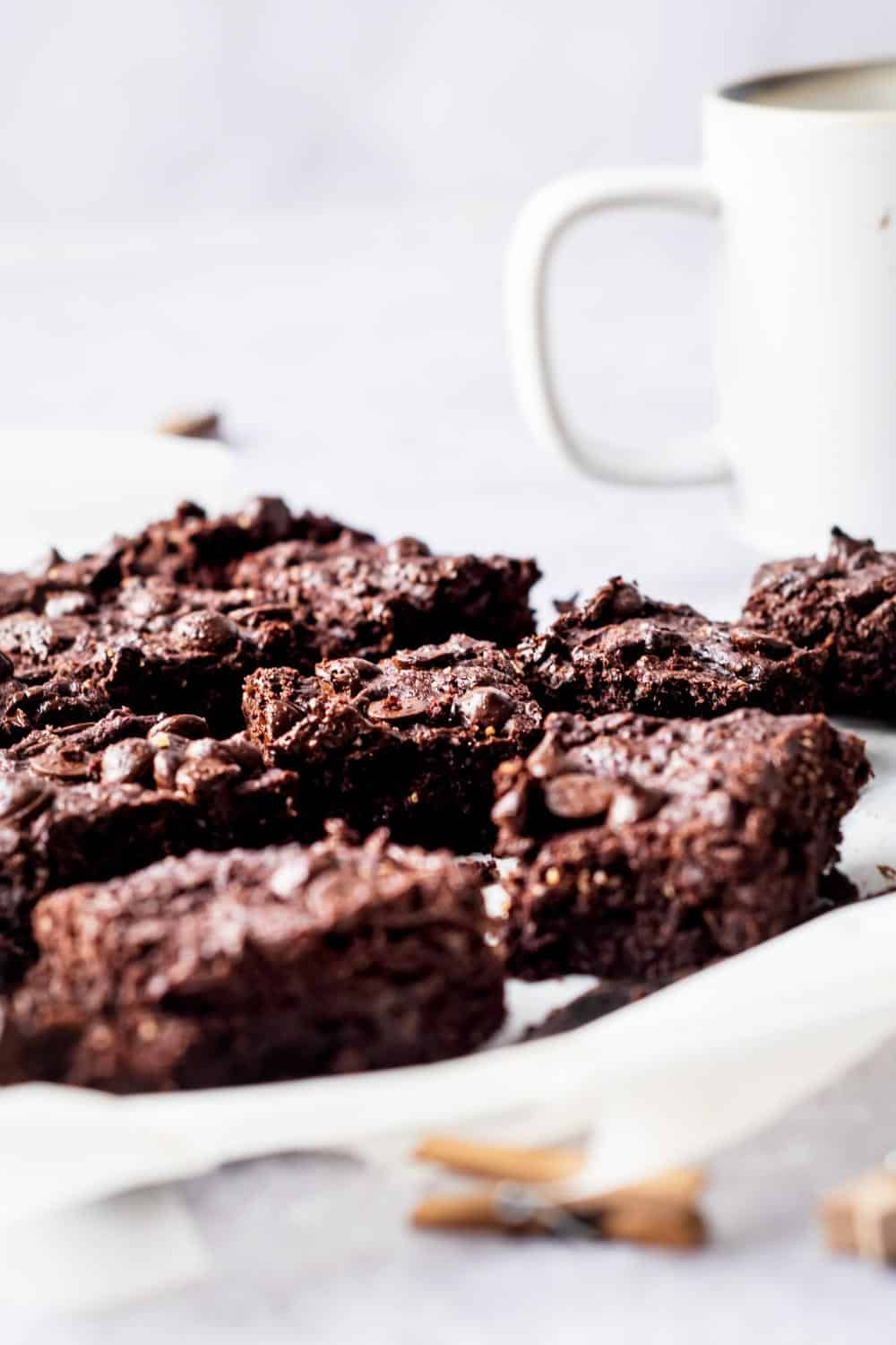 A bunch of brownies on a piece of parchment paper.