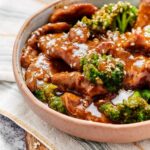 Part of a bowl of beef and broccoli stir fry.