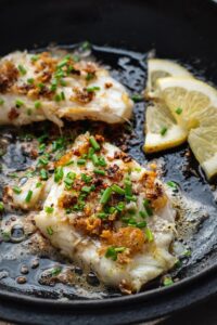 Two pan seared mahi mahi fillets in a skillet.