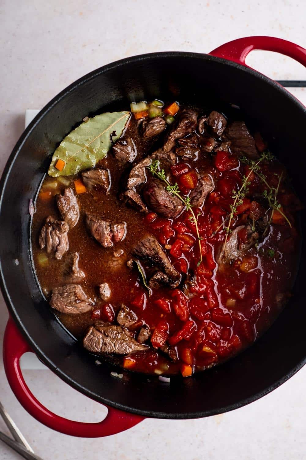 Carne picada in a tomato sauce in a Dutch oven.