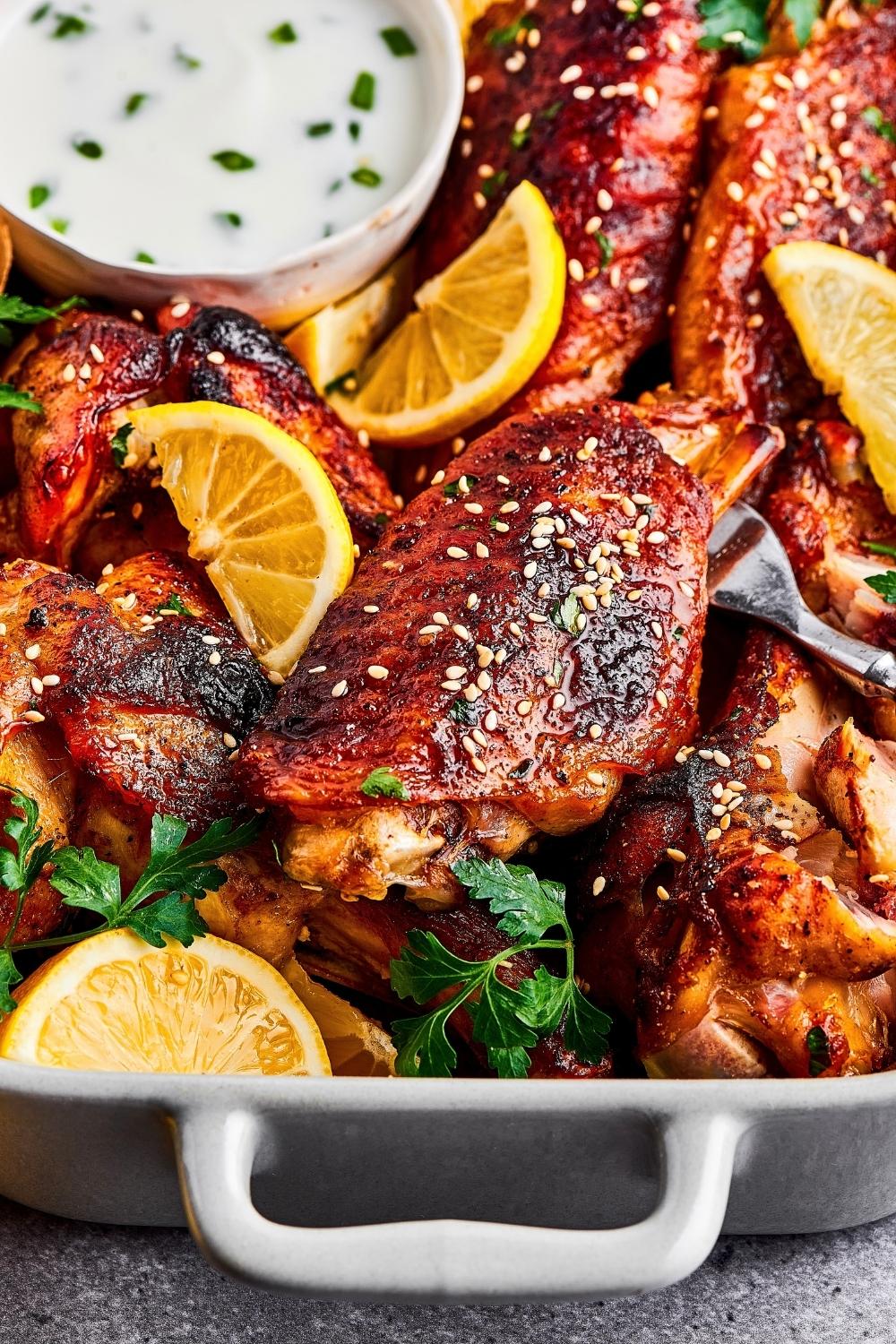 Part of a casserole dish filled with turkey wings.