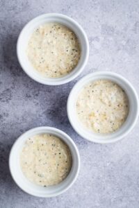 Three bowls in a row filled with overnight oats.