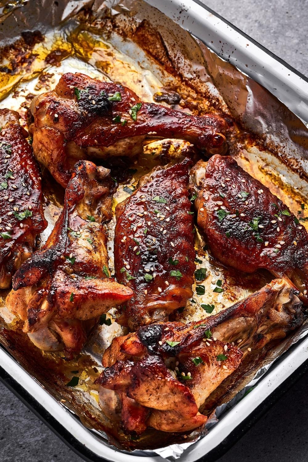 Crispy baked turkey wings in a tin foil lined casserole dish.