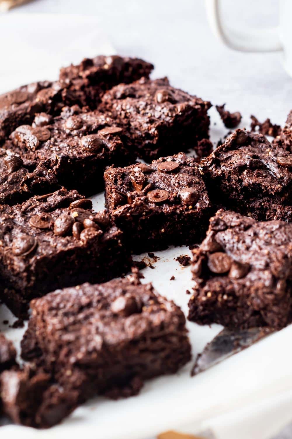 A bunch of keto brownies on parchment paper.